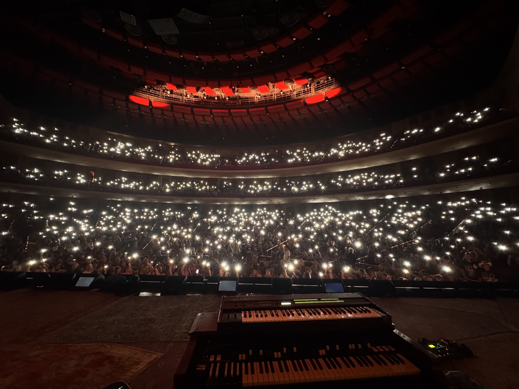 An arena crowd holding up phone lights