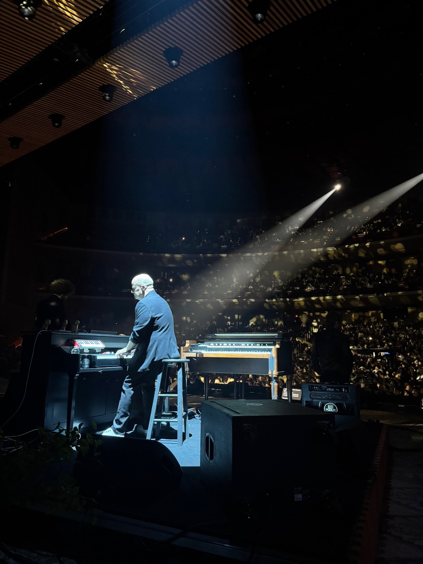 Jason under a single spotlight at the piano